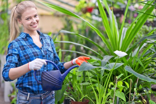 Gardeners sorting green waste into labelled containers at a Stratford site