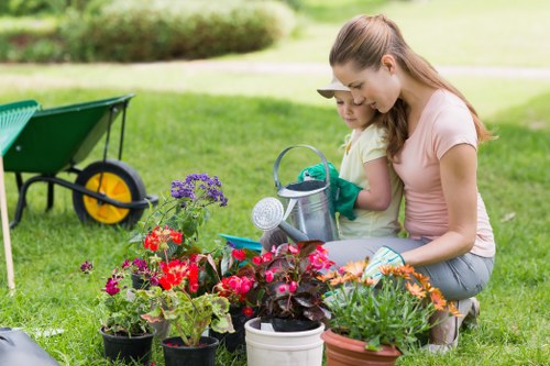 Gardeners wearing PPE and performing safe landscaping tasks